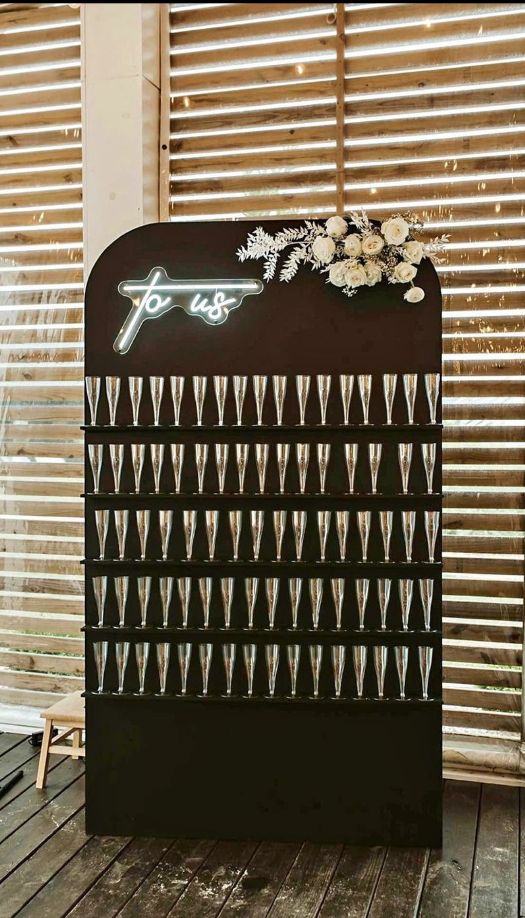 Champagne Wall with “To Us” Neon Sign